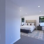 Plan 288-0237 primary bedroom with large windows and modern decor