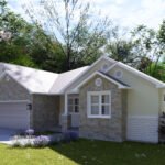 Plan 288-0256 Front view of a home with stone accents and garage