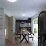 Plan 288-0131 dining room with large table and modern kitchen view