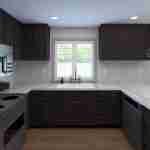 Plan 288-0131 Modern kitchen with dark cabinetry and marble countertops