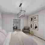 Plan 288-0118 primary bedroom with textured headboard and artwork