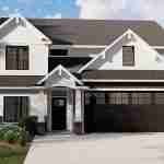 Plan 580-1346 Front view of a two-story home with a gable roof and garage