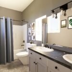 Plan 580-1373 primary bathroom with double vanity and shower curtain